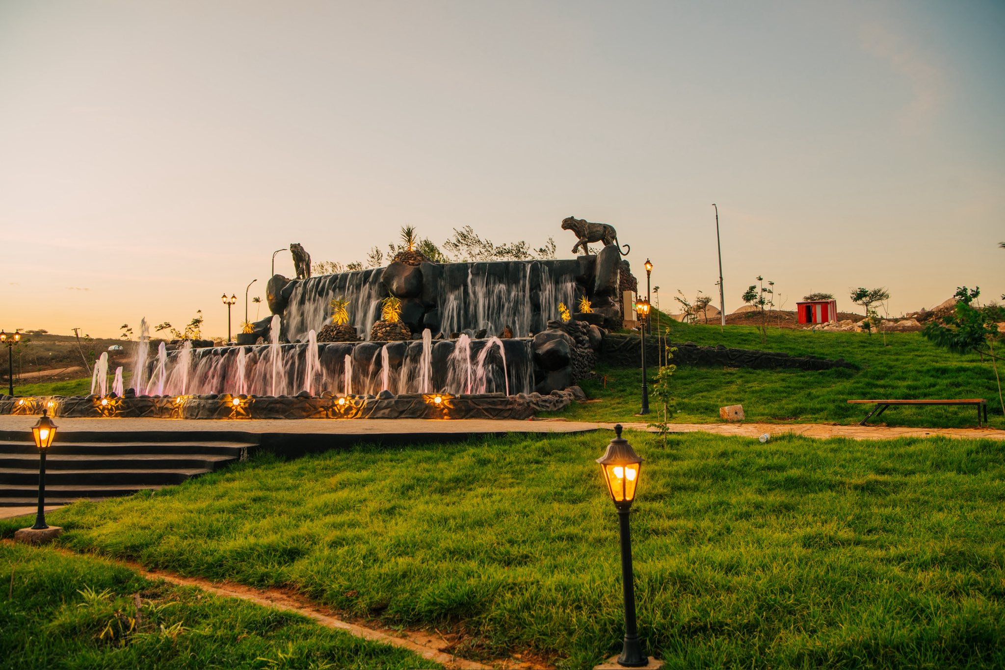The leopard fountain by day, water cascading past the sculptures
